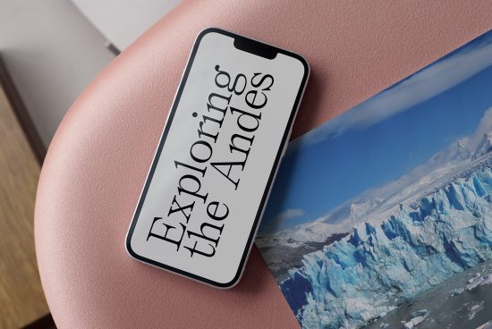 Smartphone mockup with scenic Andes wallpaper on screen, placed on a pink surface for graphic design display.